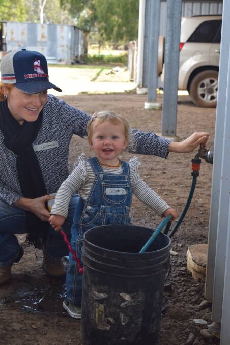 16 month old Sophia helping her mum fill a bucket of water to make biofertiliser at the recent soil health workshop they hosted. 