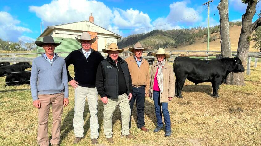 James Higgins, Curracabark, Gloucester, Paul Dooley, auctioneer, Nutrien Ag Solutions' livestock manager, John Settree with Guy and Suz Lord, Branga Plains, Walcha, with Curracabark Snowman, which sold for $20,000.