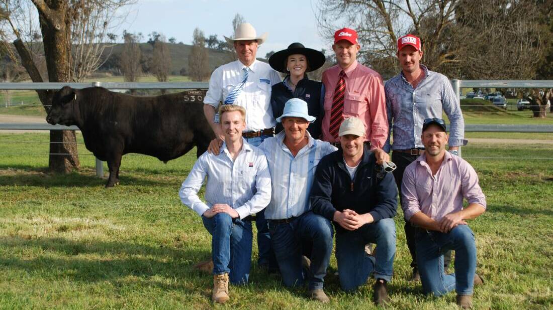 Auctioneer Paul Dooley, Annie Pumpa, ABS Australia, Andrew Bickford, Elders, Trent Walker, with (front) Fletch Kelly, ABS Australia, Ross Thompson, Millah Murrah, Will Couch, Couch Pastoral, and Rob Swinton with the $200,000 top-priced bull.