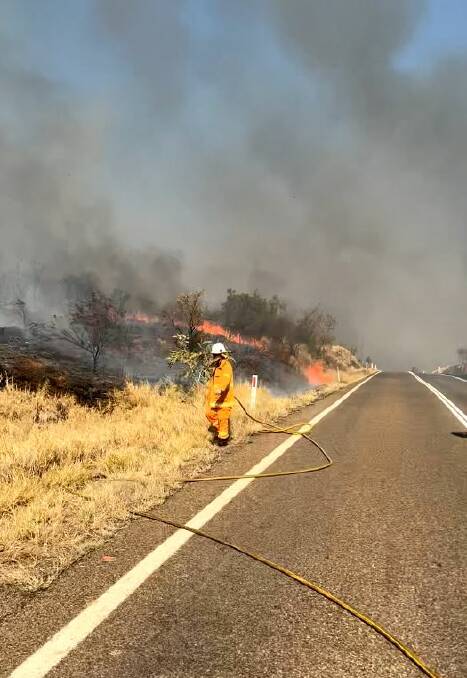 A firefighter battles a blaze burning near Mount Isa. Picture by Queensland Fire and Emergency Service