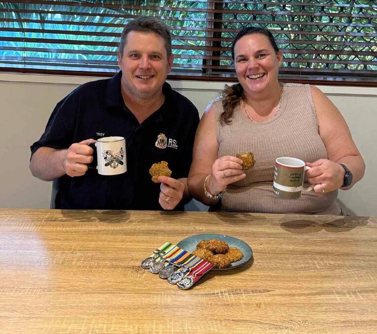 Amanda Turner shares a batch of ANZAC biscuits with Mount Isa RSL president Troy Hartas, a 20 year veteran who served in the Royal Australian Navy and retired a petty officer systems supervisor operator. Picture: Supplied