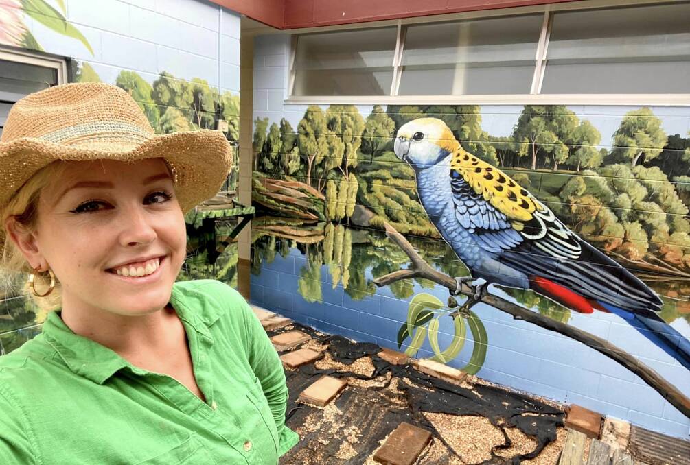 Visual artist Lavinia Letheby wit one of her striking murals she was commisisned to create in Charters Towers. Picture: Supplied 