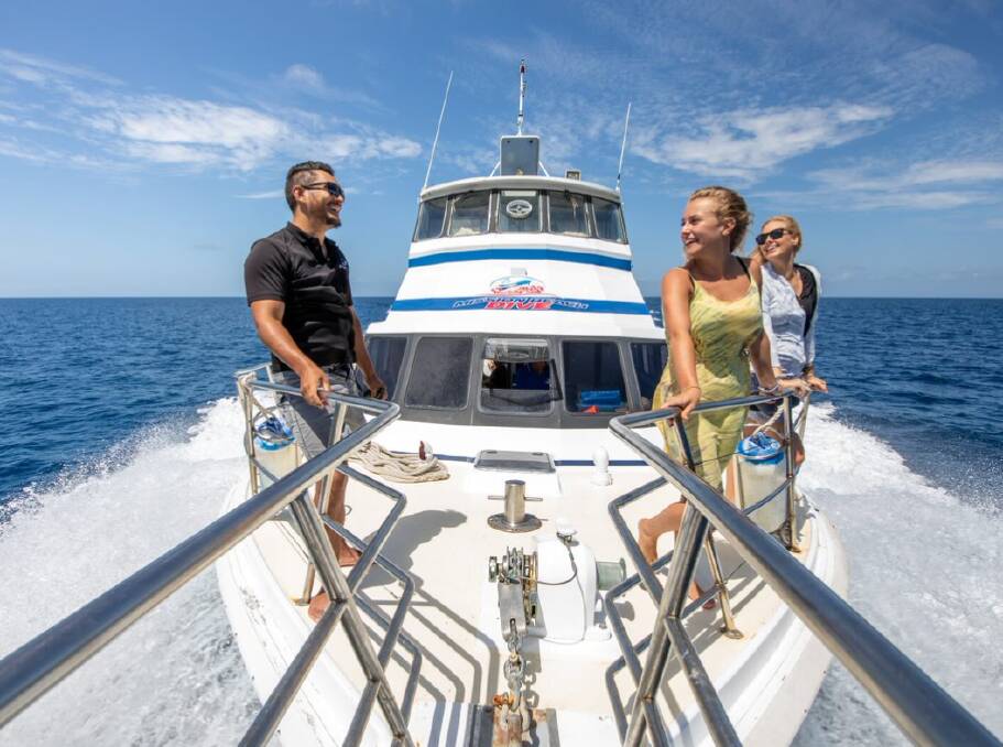 Guests enjoying the sunny tropical weather aboard the Reef Goddess. Picture: Philvids/Cassowary Coast Tourism