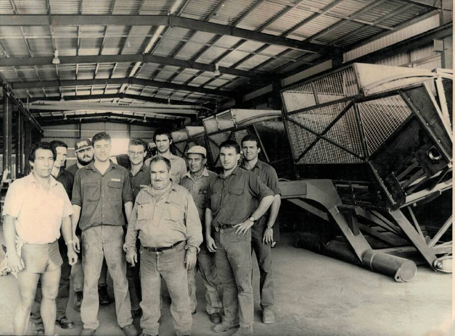 Tony Carta (front centre) with his crew and one of the early models of the transporter. Picture: Carta & Co