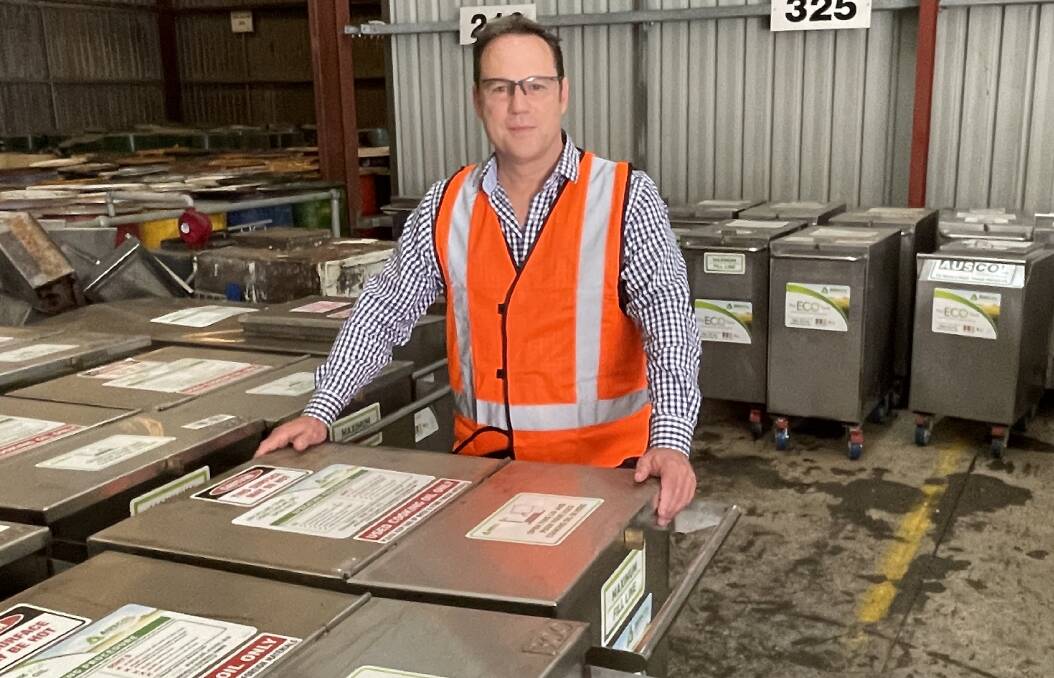 Auscol business manager, Michael McGuire, with portable used cooking oil collection units which the company supplies to many of its food business customers. Photo Andrew Marshall.