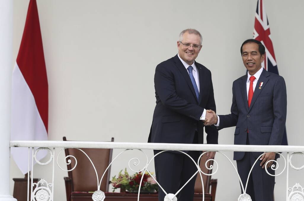 Australian Prime Minister Scott Morrison shakes hands with Indonesian President, Joko Widodo, during their meeting at the Presidential Palace in Bogor, West Java, Indonesia.