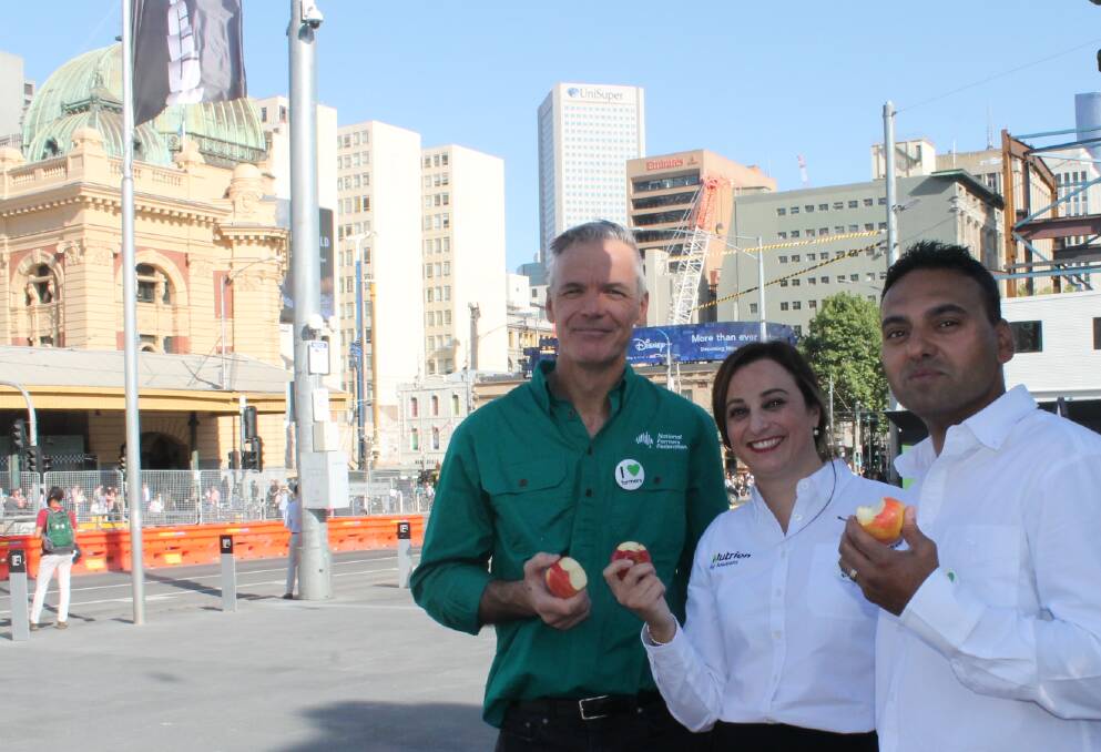 National Farmers Federation chief executive officer, Tony Mahar, with Nutrien Ag Solutions staff Clare Darmanin and Lloyd Dias out selling the farming story with city workers in Melbournes Federation Square last week.