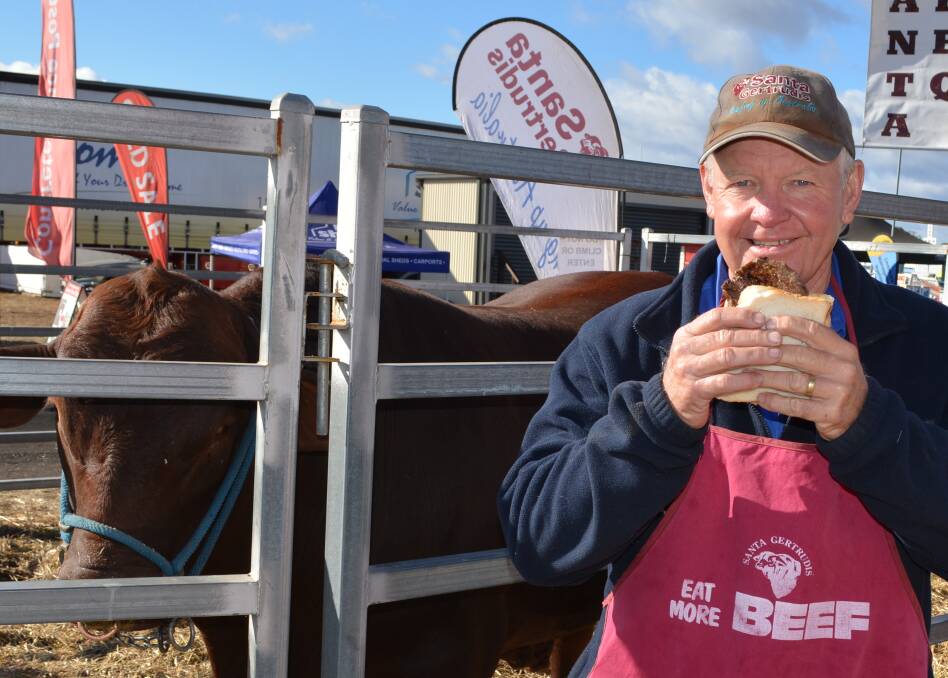 Santa Gertrudis Breeders' Association general manager, Chris Todd, samples a real piece of beef at AgQuip field days.