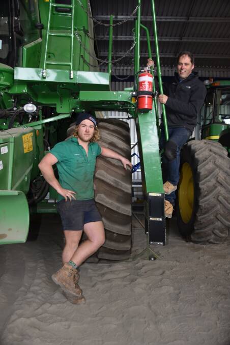 Bartlett Brothers Contract Harvesting's Lachlan Barber and Chris Bartlett with one of the fleet of John Deere headers that will not be heading north to NSW this season due to the drought.