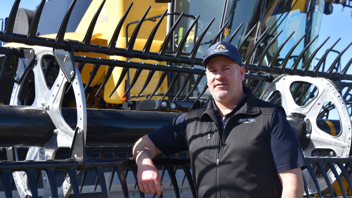 THE REEL DEAL: Michael Kelly, Bellevue Machinery Swan Hill, with one of the New Holland range of harvesters at the Mallee Machinery Field Days.