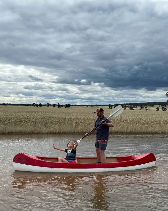 WEATHER FOR DUCKS: Brad Morris takes son Lachlan on a once in a life time aquatic crop tour at the family's property between Barellan and Narrandera. The northern Riverina bore the brunt of heavy storms last week. Photo: Sarah Morris.
