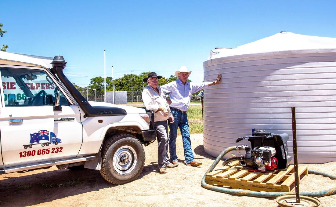Aussie Helpers founder Brian Egan with Colinta Holdings general manager Gary Johncock at the liquid feed depot which has been installed at the Dalrymple Saleyard, Charters Towers, with a portion of the $100,000 donation Colinta has given Aussie Helpers.