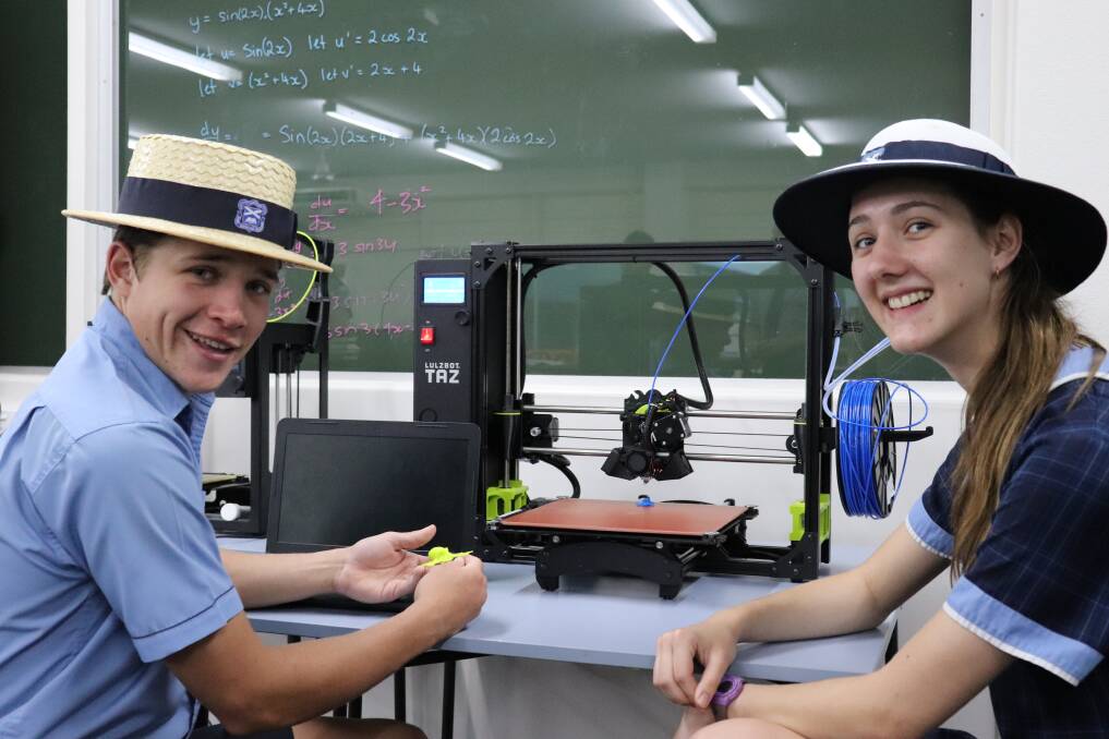 Tech savvy: Blackheath and Thornburgh College's Reg Batt, Richmond, and Kate McCullough, Charters Towers, use a 3D printer at the technologically rich school.