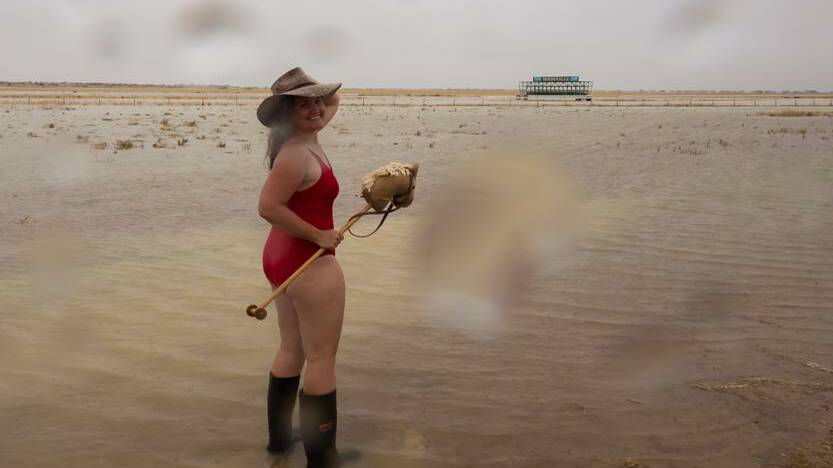 There's been so much rain at notoriously dry Birdsville this week that race club secretary Jenna Brook took her (hobby) horse for a paddle in togs and gumboots. Picture - Jess Scott