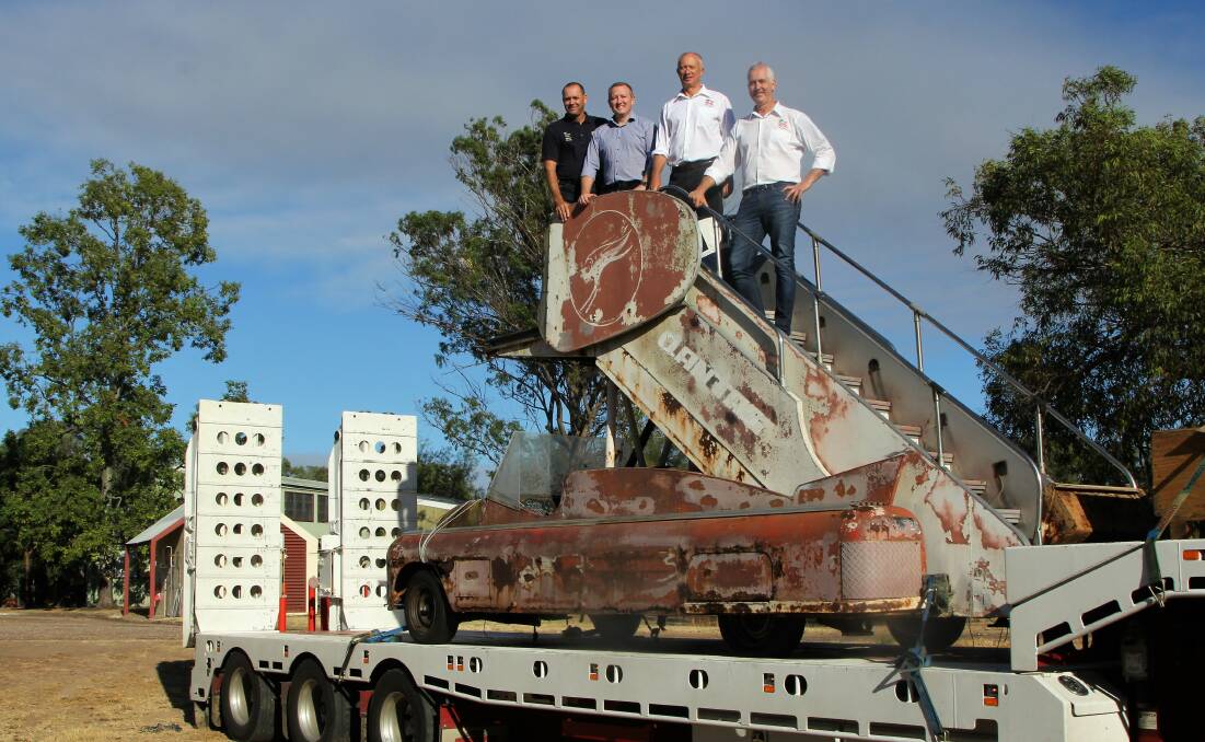 Claude Favero, CQUniversity Emerald campus VET leader, associate vice chancellor, Blake Repine, Qantas Founders Museum director and A380 pilot, Don Hill, and QFM CEO, Tony Martin, taking delivery of the 'Batmobile' at Emerald.