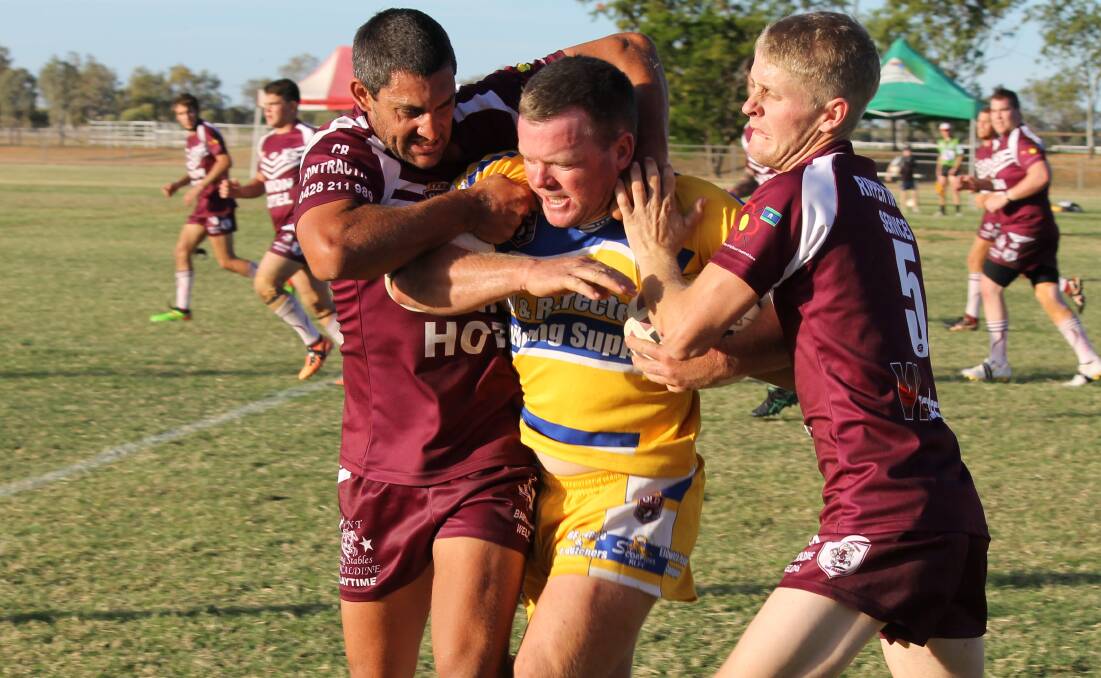 Ilfracombe in the yellow and blue on the paddock in 2015 against Barcaldine, three years into the drought that has stripped towns of player numbers in western Queensland.