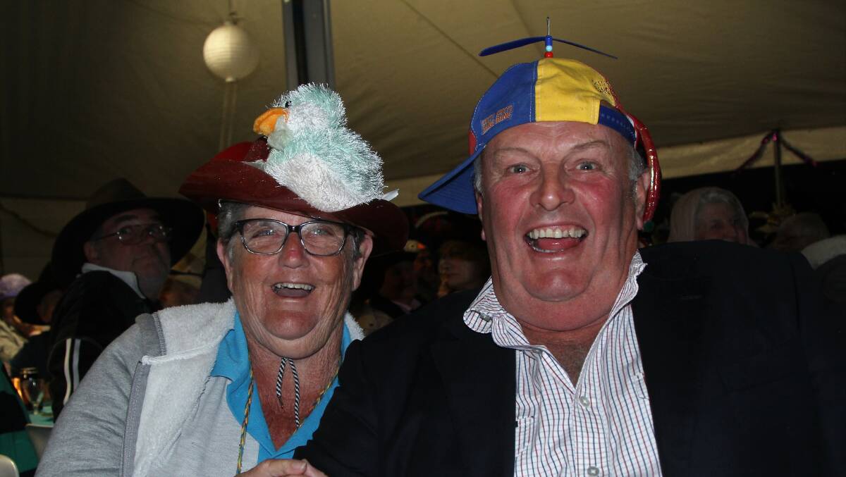 Solo rally organiser Roz Clenton, who hails from Casino, helps Blackall-Tambo mayor Andrew Martin get in the spirit at the welcome dinner, which had a funny hat theme.