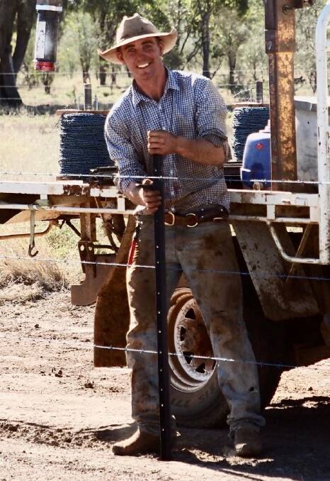 My Footprint app inventor Sam Curr hard at work fencing in western Queensland. Picture: Supplied