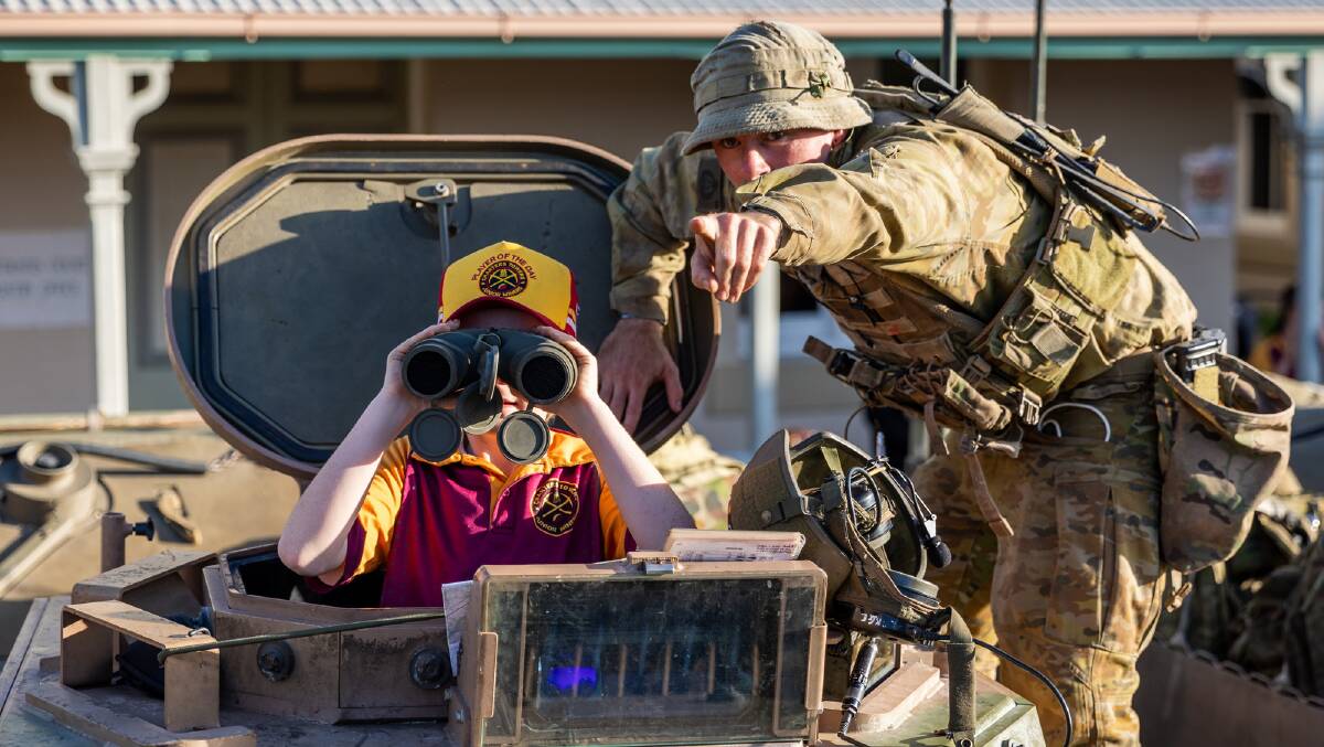 An Australian Army soldier from 3rd Battalion, Royal Australian Regiment interacts with a Charters Towers local at the Exercise Brolga Run 2022 community open day. Picture: Gregory Scott