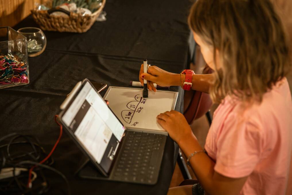 A distance education student doing her schoolwork at the ICPA conference. Photos: SweetSpot Pictures