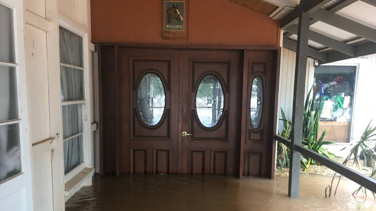 The sign above the door says 'welcome' but floodwater at Thorntonia Station, Camooweal, was anything but. Picture supplied by Wendy Hick.