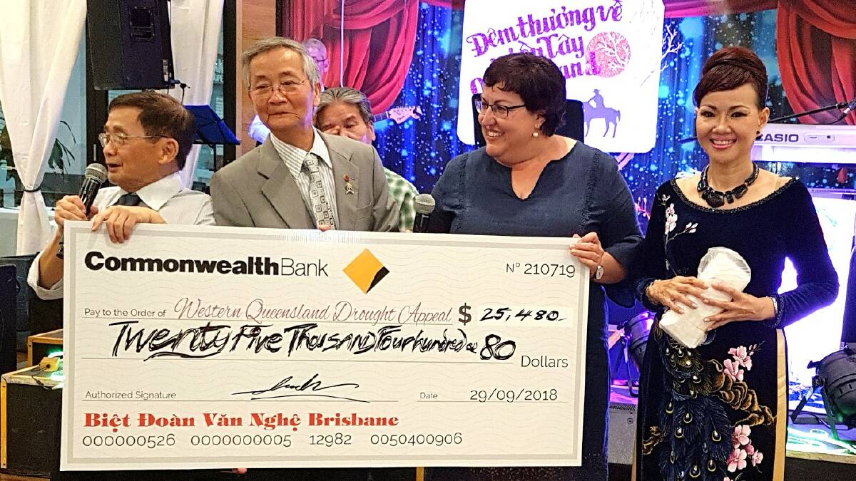 Mr Tran and other Brisbane Vietnamese community members present a cheque to Nicole Heslin, representing the Western Queensland Drought Appeal.