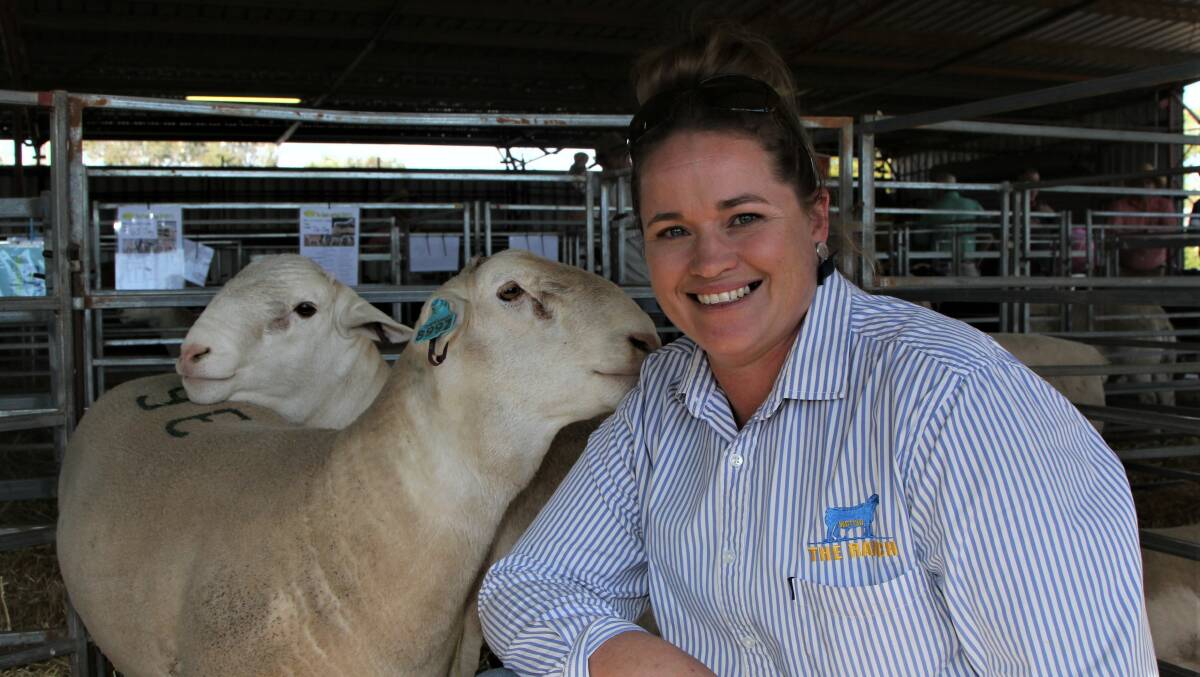 Melinda Davies, The Ranch, Longreach gets a cuddle from one of the White Dorper rams she sold at the St George Dorper and White Dorper sale on Monday.