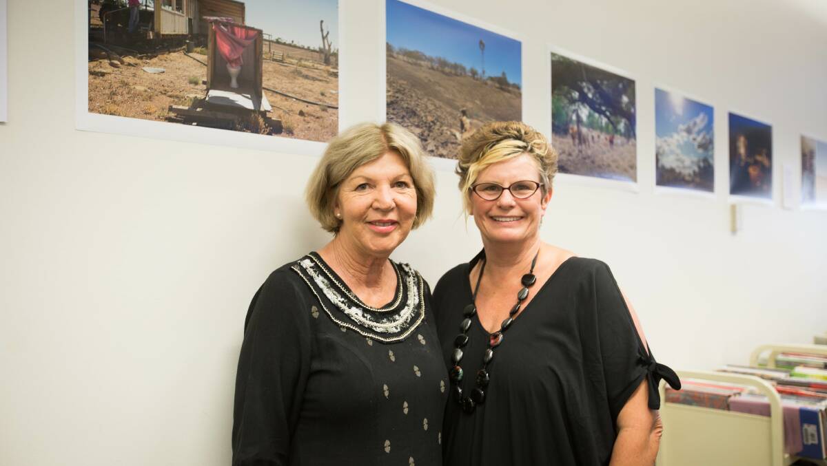 Sue Moody and photographer Libby Best, in front of Libby's photojournalism project done for the Wesley Mission for Anti-Poverty Week.