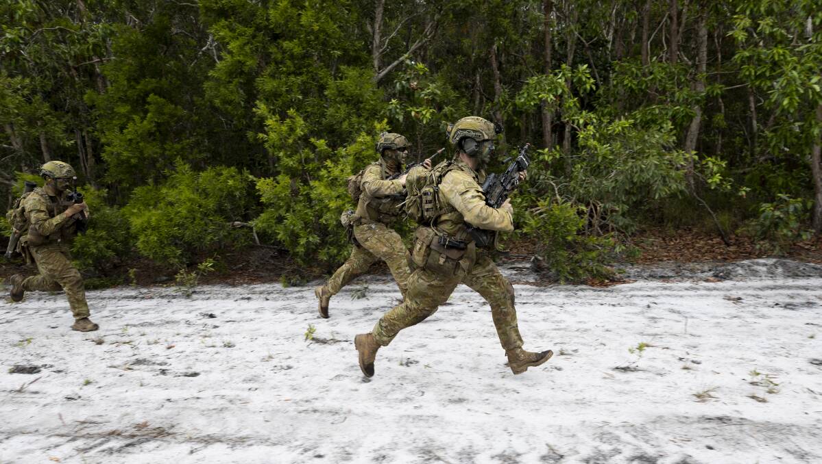 Australian Army soldiers from the 1st Battalion, The Royal Australian Regiment run to the next objective during a clearance patrol through Cowley Beach Training Area as part of the combined arms training activity. Picture: Cpl Brodie Cross.