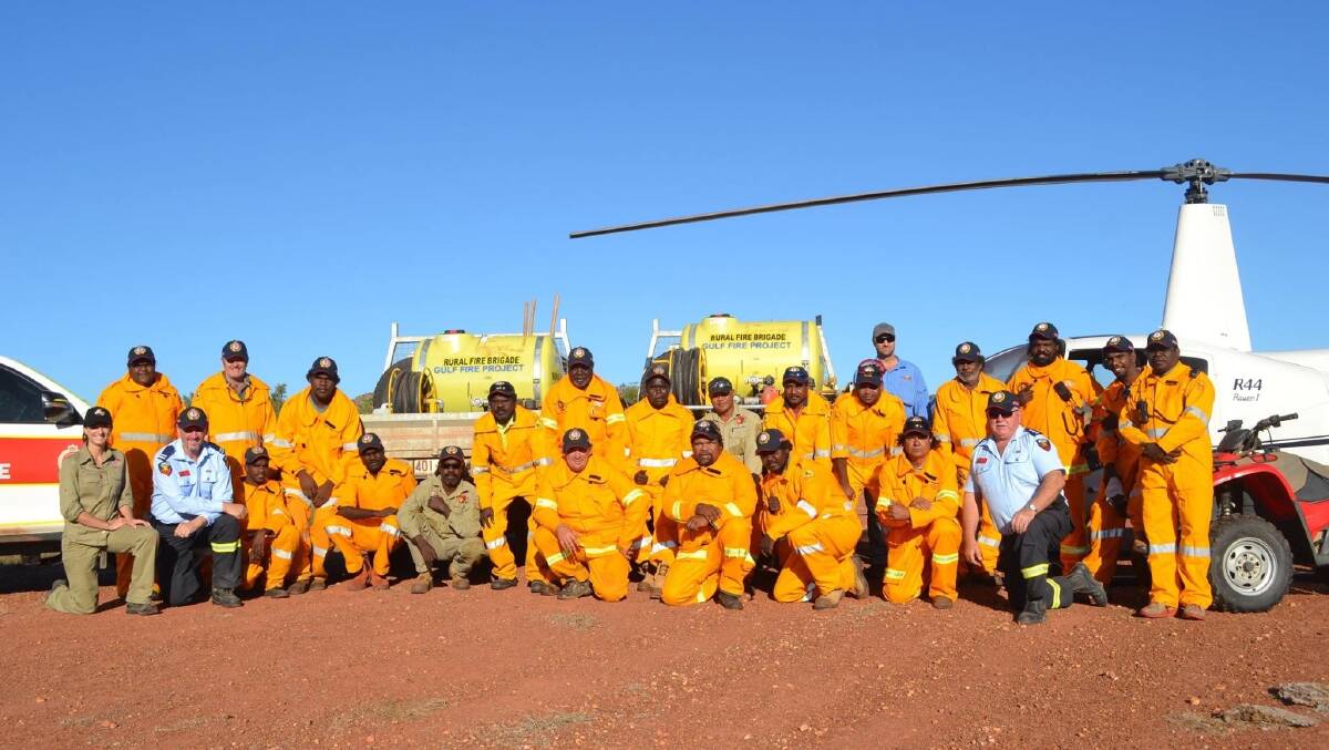 Gavin Fryar, front second left, at a Mornington Island shed installation. Pictures supplied.