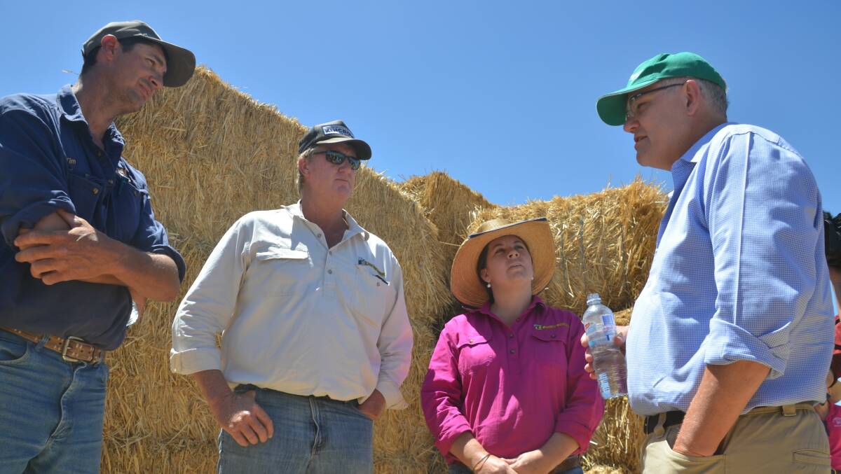 Prime Minister Scott Morrison with Julia Creek business owners Tim Pratt and Michael and Karena Leake on his trip to north west Queensland. Producers and small business alike are awaiting the types of assistance measures that will be announced. Photo - Derek Barry.