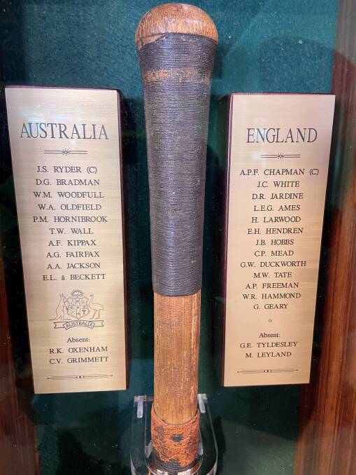 The names on the bat have been listed in the case now preserving the bat.