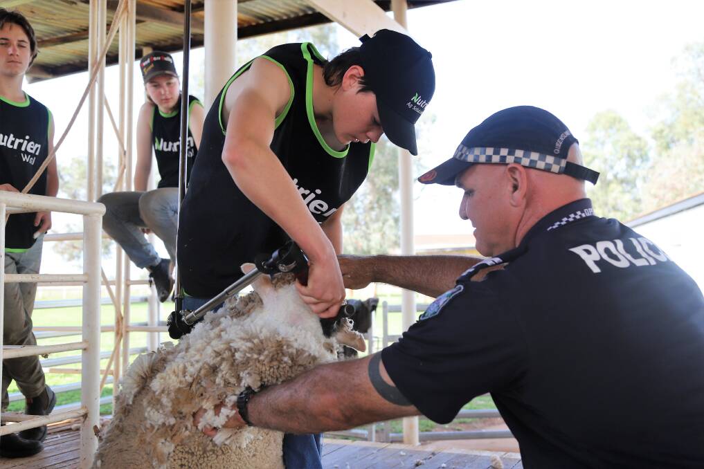 Blue Light Shearing founder Laurie Bateman, right, passing on tips to a participant in the school at Charleville in 2022. Picture: Sally Gall