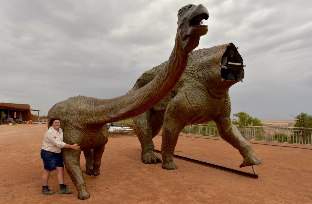 Trish Sloan hugs one of the bronze dinosaurs during the construction process at the Australian Age of Dinosaurs. Picture: John Elliott