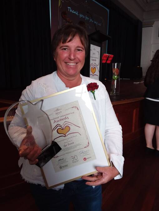 Lyn French proudly displays her Volunteer of the Year award after the presentation ceremony.