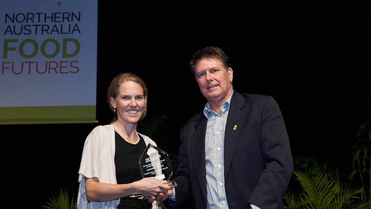 FRAP project officer Sara Westaway receiving the Food Futures Award at the Darwin conference from Northern Territory Farmers Association president Simon Smith>