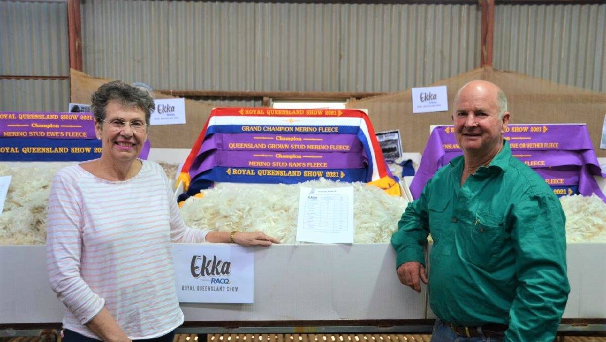 Narda and Will Roberts, Victoria Downs, Morven with the 2021 RNA grand champion Merino fleece. Photo: supplied