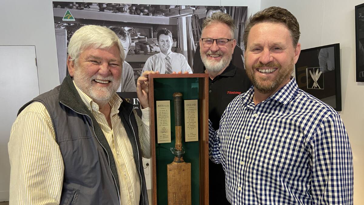 Former Thornburgh College staff member Ian Doyle OAM, along with master craftsman David Pfitzner and Pfitzner Furniture managing director Andrew Pfitzner, with the Thornburgh Bat safe in its new case. Pictures: Supplied