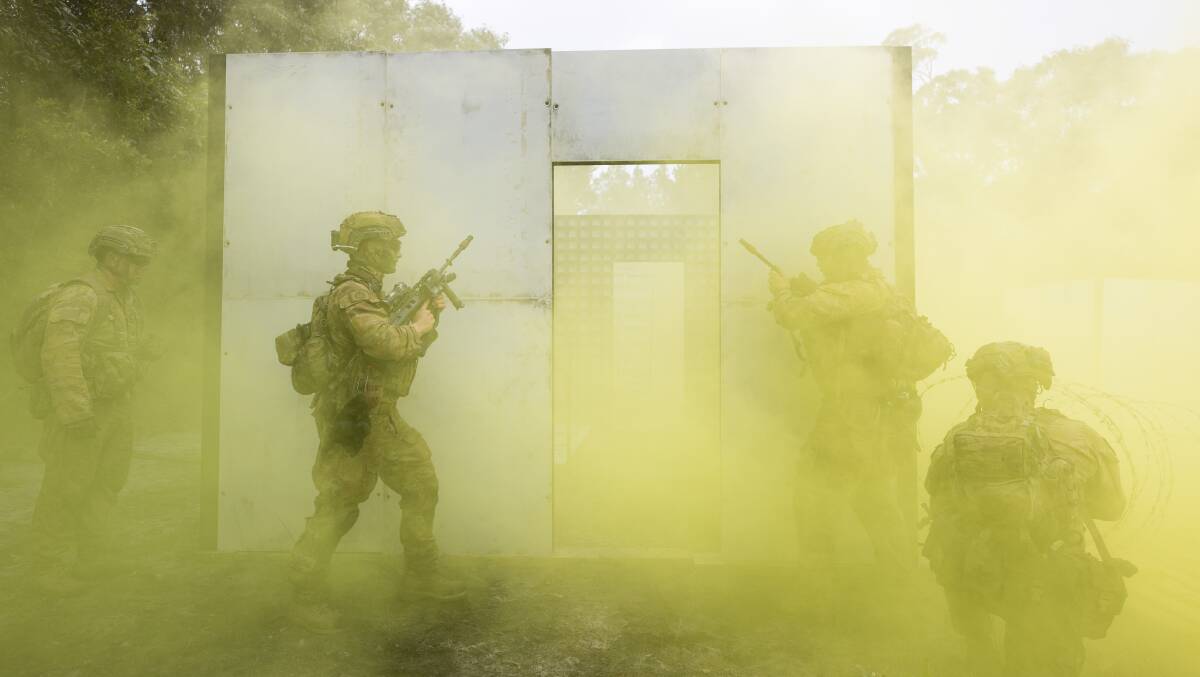 Australian Army soldiers from the 1st Battalion, The Royal Australian Regiment prepare to breach a room during clearance a patrol through Cowley Beach Training Area. Picture: Cpl Brodie Cross