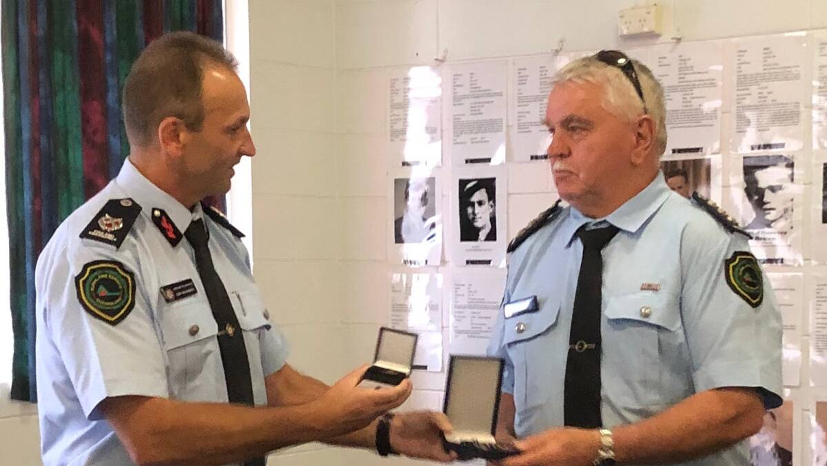 Gavin Fryer being presented with a long service medal.