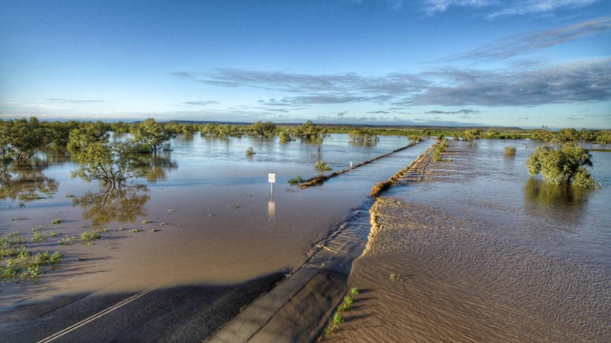 Floodwaters crossing the causeway on Dinosaur Drive at Winton, leading to the Australian Age of Dinosaurs Museum. Picture: Trish Sloan