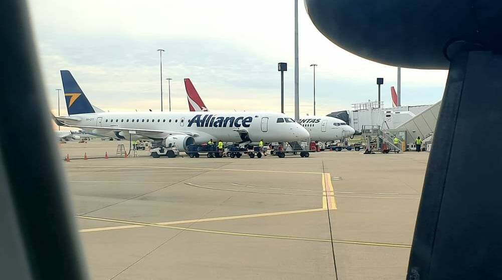 A glimpse of planes docked at Brisbane Airport from a QantasLink plane on the tarmac. Picture: Sally Gall
