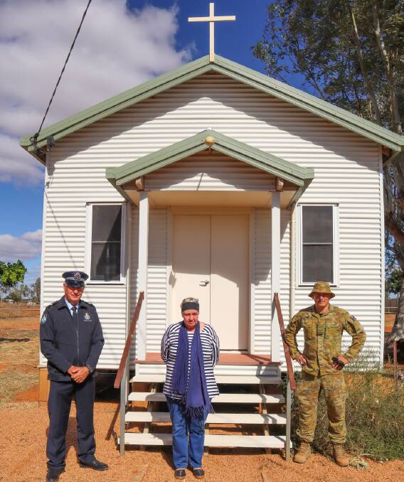 Australian Army soldier Lance Corporal Brodie Paul (right), president of the Windorah Development Board Marilyn Simpson (middle) and Senior Constable Rob Edwards (left) from the Queensland Police Service, in front of the Catholic Church newly-renovated by soldiers deployed on Operation COVID-19 Assist in Windorah.