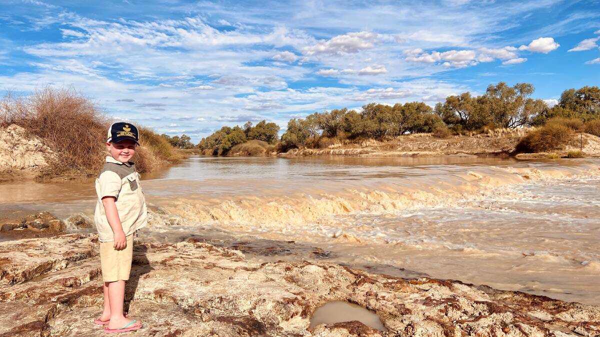 Five-year-old Louis Hussey checking for fish at the Old Crossing on the Diamantina River, following in the footsteps of generations of the Brook family before him. Picture: Karen Brook