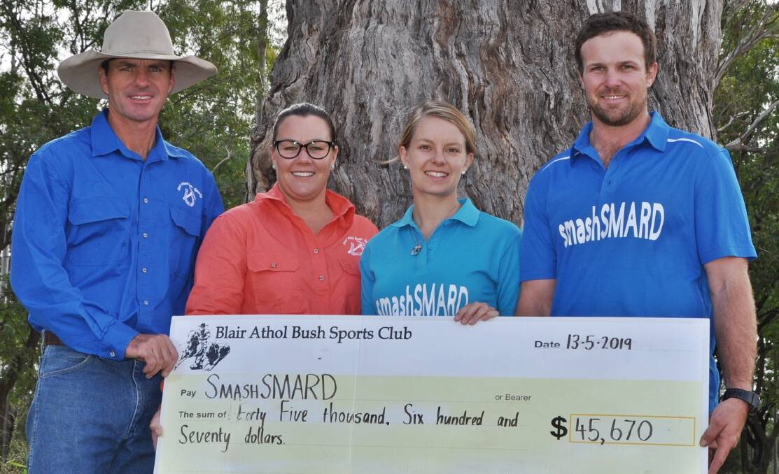 Blair Athol Bush Sports president Jeff Cook and treasurer Elise Lawrence handing over a cheque to SmashSMARD representatives and fellow committee members Dean Williams and Crystal Watson.