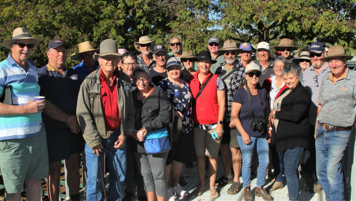 Local identity Stew Benson, fourth left, has gone from tailing out cattle after sales in the 1970s to explaining how saleyards operate to tourists. Photo: Sally Gall