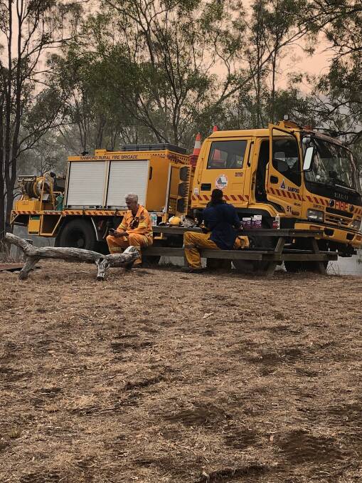 Samford Rural Fire Brigade members taking some time out after a night protecting assets on a rural property at Thornton. Picture: Supplied