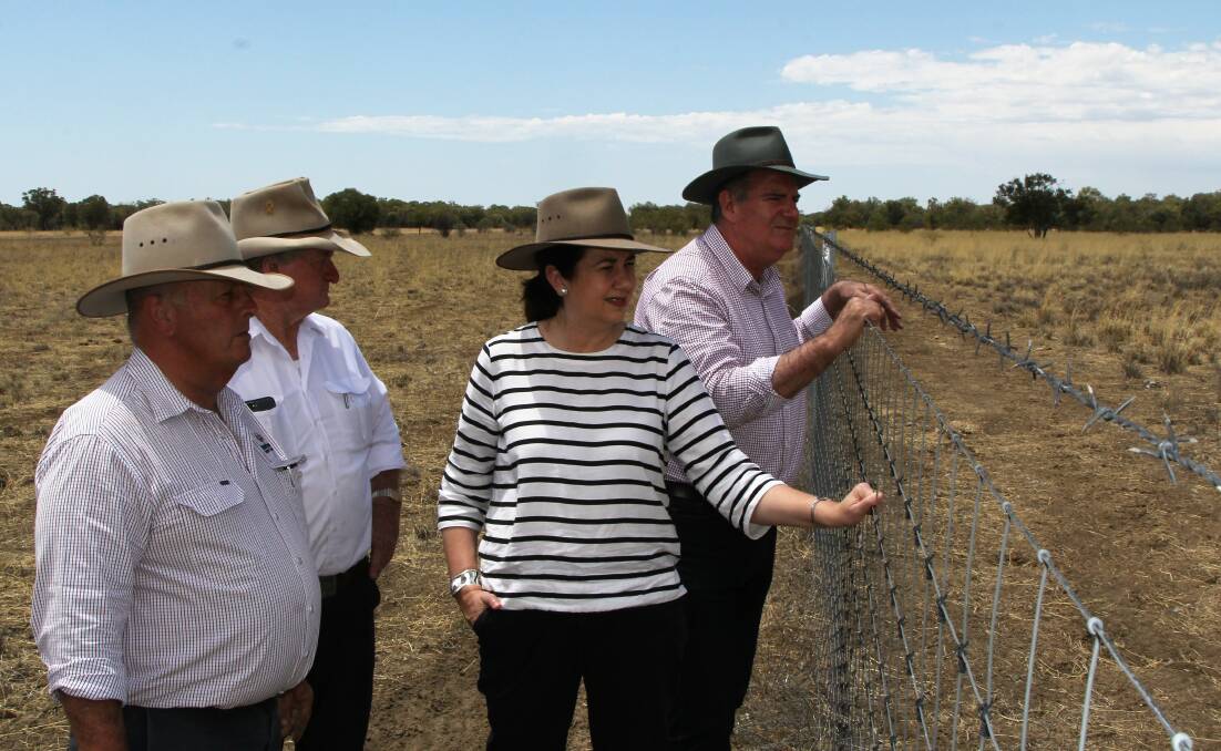 Blackall-Tambo mayor, Andrew Martin, and drought commissioner, Vaughan Johnson, inspecting an exclusion fence at Blackall with Premier Annastacia Palaszczuk and Agriculture Minister, Mark Furner. Picture - Sally Cripps.