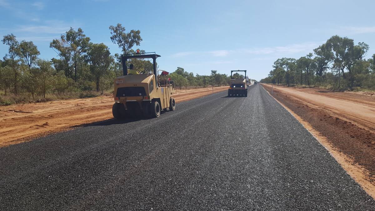 Flinders Shire Council workforce putting the final touches on the bitumen road seal. Picture: Supplied