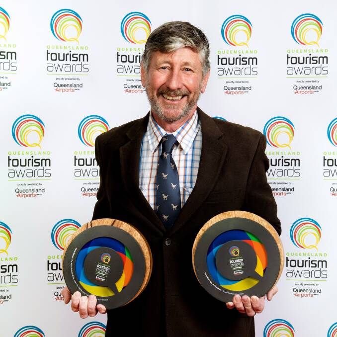 David Elliott displays his individual tourism award and the gold award for the Australian Age of Dinosaurs. Pictures supplied.